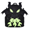 A black faux-leather backpack shaped like a dragon head, featuring glowing neon green eyes and flame-like accents, set against a plain white background.