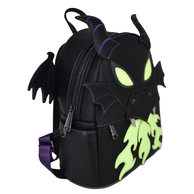 A black faux-leather backpack designed like a dragon head, featuring purple stitching, glowing neon green eyes, a neon green flame-like mouth, and small black wings on the sides, shown on a plain white background.