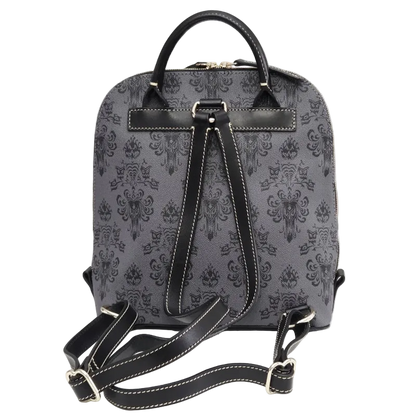 A gray and black damask-patterned backpack with black leather handles, trim, and adjustable shoulder straps, displayed on a white surface against a light gray background.