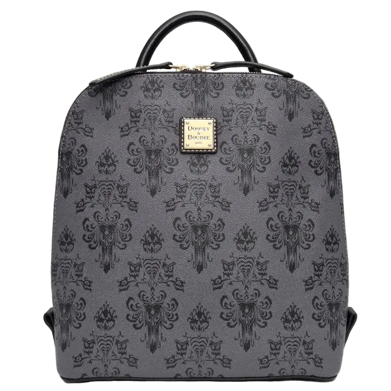 A gray and black damask-patterned backpack with a top handle and a gold-tone Disney on Parade logo plaque on the front, set against a neutral gray background.
