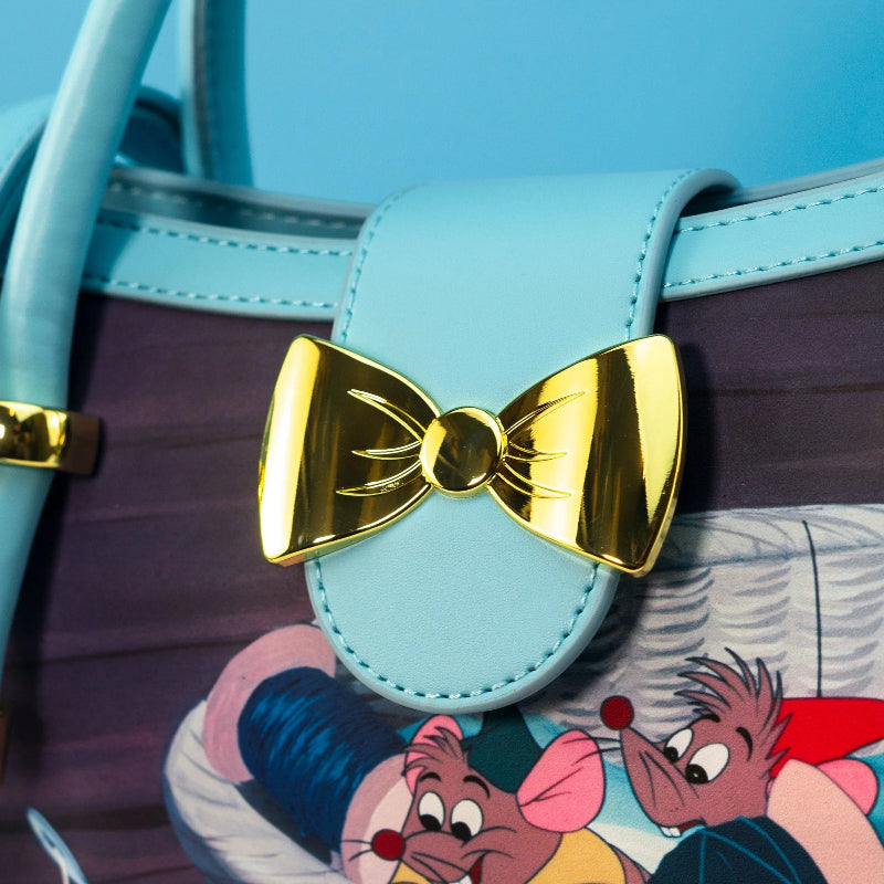 Light blue handbag with a gold bow detail on a colorful background