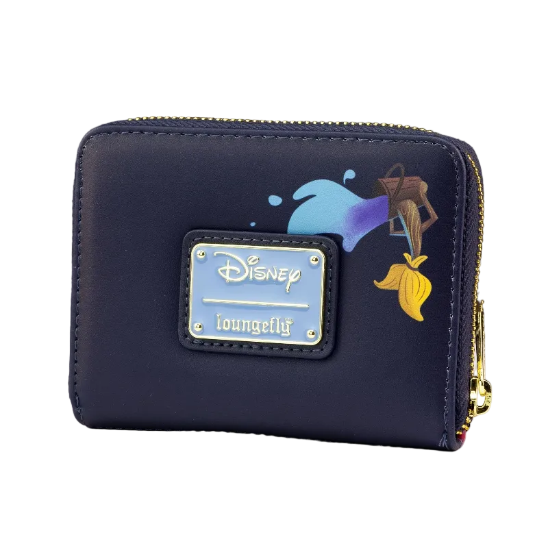 A navy blue zip-around wallet featuring a metallic silver Disney Loungefly plaque on the front, decorated with a blue and purple splash graphic and a yellow genie lamp keychain illustration. The wallet is shown on a white surface with a black background.