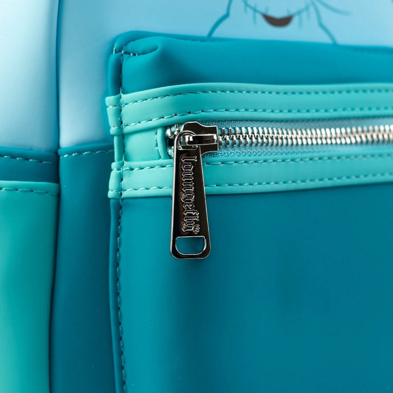 Close-up of a turquoise and light blue bag with a silver zipper and a visible 'Longchamp' pull tab.