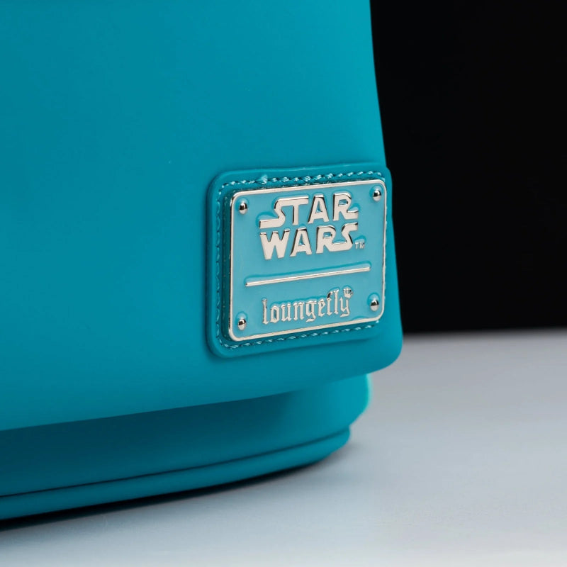 Close-up of a turquoise blue bag featuring a silver metal plaque with the embossed 'Star Wars' logo and the brand name 'loungeilly' stitched below it.