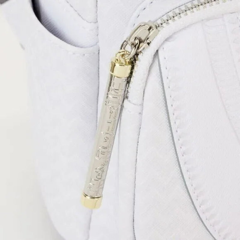 Close-up of a white jacket with a gold and silver zipper