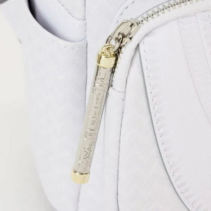 Close-up of a white jacket with a gold and silver zipper