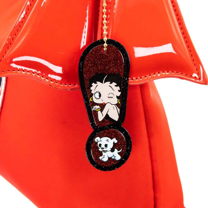 Betty Boop sandal charm on a red surface