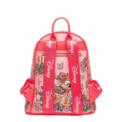 A pink Disney-themed mini backpack featuring Bambi illustrations and floral patterns, with bright pink straps printed with the Disney logo.