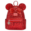 A red sequined mini backpack featuring Minnie Mouse ears, a large shiny red bow, and a silver snowflake charm, shown on a plain white background.