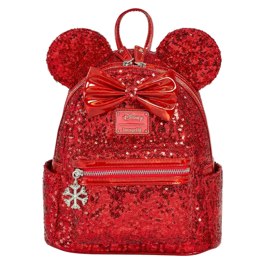 A red sequined mini backpack featuring Minnie Mouse ears, a large shiny red bow, and a silver snowflake charm, shown on a plain white background.