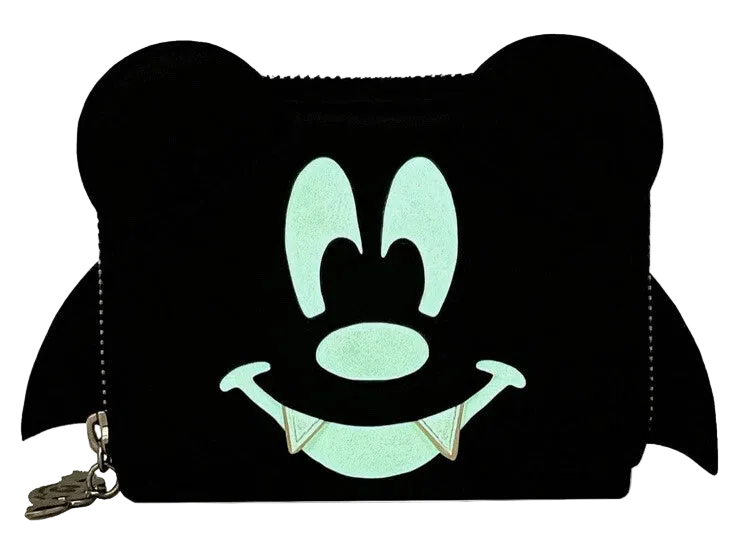 A black coin purse designed like a cartoon character's face with large round ears, a smiling mouth with fangs, and a small gold-tone zipper pull on a white background.