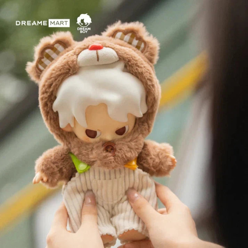 Plush toy with bear ears held by a person, brand 'Dreame Mart' visible