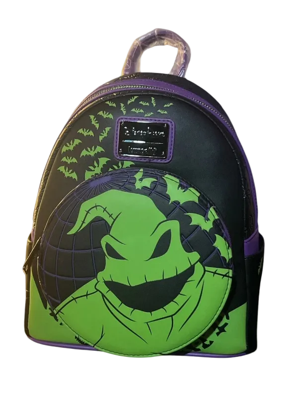 Backpack with green face design on a white background