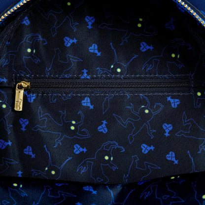 Close-up of a dark fabric with blue glowing patterns and a gold zipper.