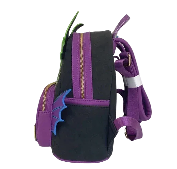 A black and purple dragon-themed backpack with green horns, blue wing details, and gold zippers, shown on a plain white background.