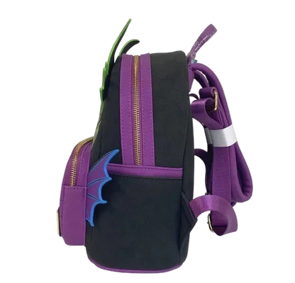 A black and purple dragon-themed backpack with green horns, blue wing details, and gold zippers, shown on a plain white background.