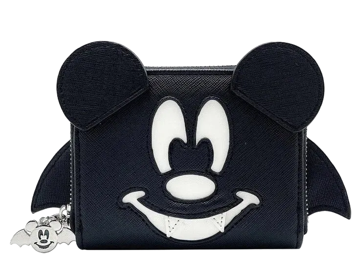 A black zip-around coin purse featuring a stylized Mickey Mouse face design in white and black, with mouse ears on top and small bat wings on the sides. A small silver Mickey-shaped charm hangs from the zipper on the left.