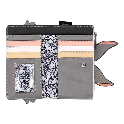 A Loungefly character wallet featuring Tom and Jerry designs, shown open on a white background. The wallet has gray faux leather sections, a black top band, pastel pink and peach card slots, a black-and-white floral patterned center panel, and cartoon character ears extending from the sides.