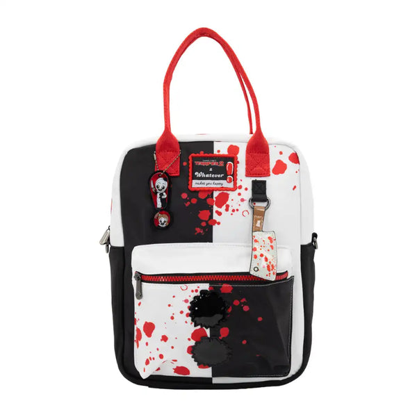 A small tote bag with a black and white split design, red handles, and red blood-splatter print. It features a front zippered pocket with a black skull patch, a hanging character charm, and a brand patch that reads 'Mortuary'.
