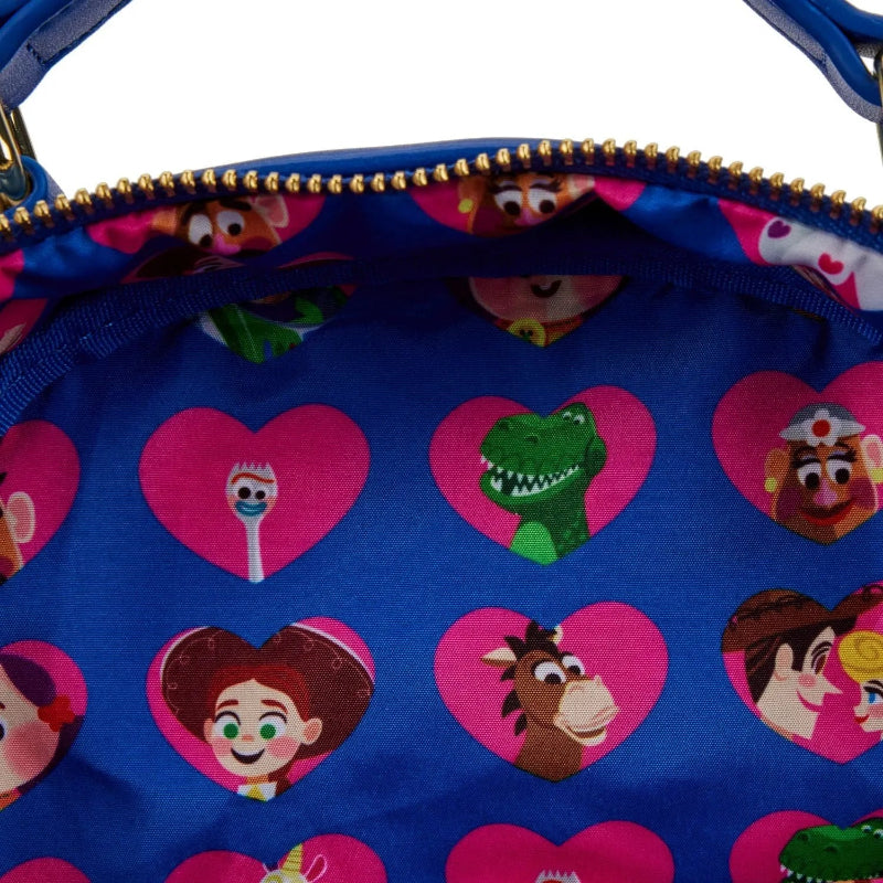 Close-up of a blue bag with cartoon character faces in pink hearts on a white background